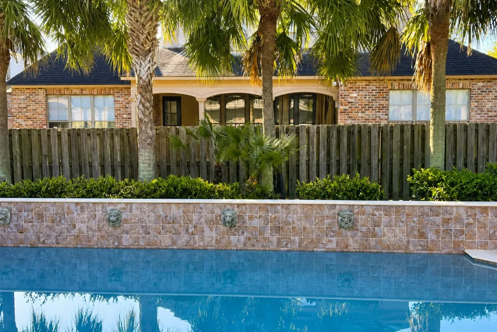 Custom swimming pool with premium plaster finish, decorative tile, and elegant water features by NOLA Pool Plastering